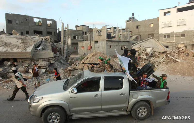 Members of Ezzedeen al-Qassam brigades, the armed wing of Hamas movement, take part in an anti-Israel parade in Beit Hanoun, in the northern Gaza Strip, on August 11, 2015. Photo by Ashraf Amra
