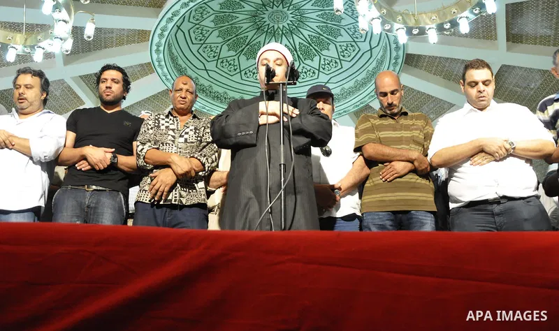 Friends and relatives of Egyptian actor Nur al-Sharif pray over his coffin during his funeral at a mosque in Sheikh Zayed City, on the outskirts of Cairo, on August 12, 2015. The veteran pan-Arab film and TV star died on...