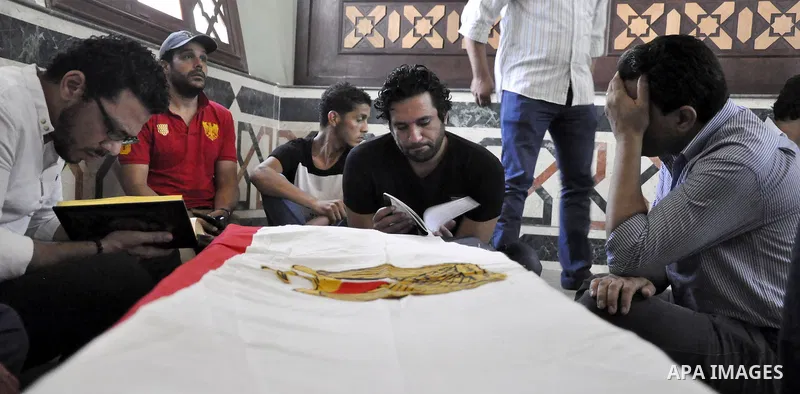Friends and relatives of Egyptian actor Nur al-Sharif pray over his coffin during his funeral at a mosque in Sheikh Zayed City, on the outskirts of Cairo, on August 12, 2015. The veteran pan-Arab film and TV star died on...