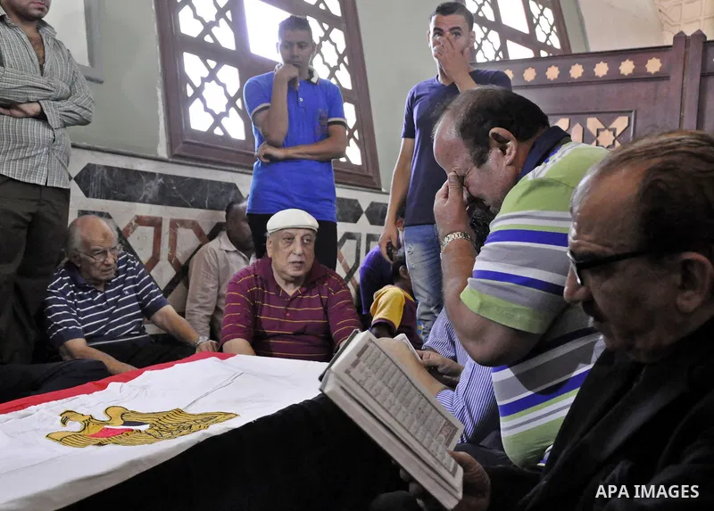 Friends and relatives of Egyptian actor Nur al-Sharif pray over his coffin during his funeral at a mosque in Sheikh Zayed City, on the outskirts of Cairo, on August 12, 2015. The veteran pan-Arab film and TV star died on...