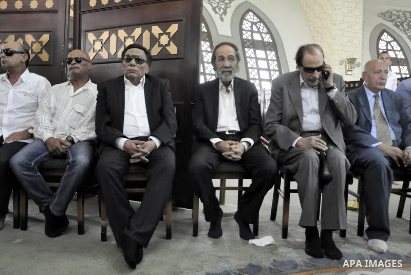 Veteran actors Adel Imam (3rd L) and Mahmoud Yassin (3rd R) attend the funeral of Egyptian film star Nur al-Sharif on August 12, 2015, at a mosque in Sheikh Zayed City, on the outskirts of Cairo. The veteran pan-Arab fil...