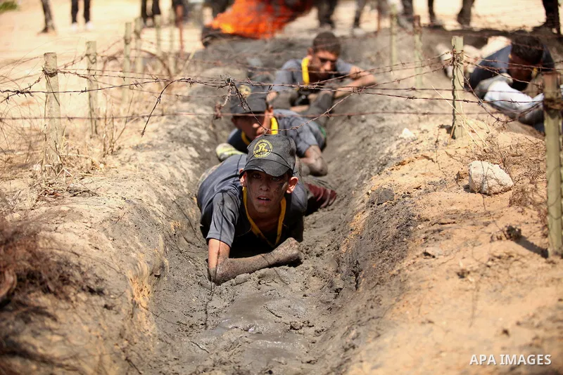 Palestinian youths take part in a military-style exercise during a summer camp organized by Islamic Jihad movement, in Gaza city, on August 13, 2015. Photo by Ashraf Amra
