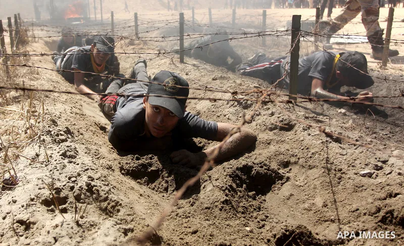 Palestinian youths take part in a military-style exercise during a summer camp organized by Islamic Jihad movement, in Gaza city, on August 13, 2015. Photo by Ashraf Amra