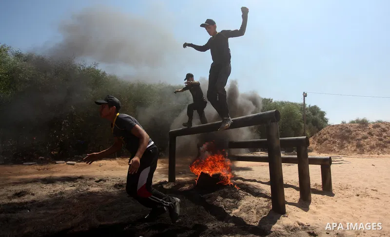 Palestinian youths take part in a military-style exercise during a summer camp organized by Islamic Jihad movement, in Gaza city, on August 13, 2015. Photo by Ashraf Amra