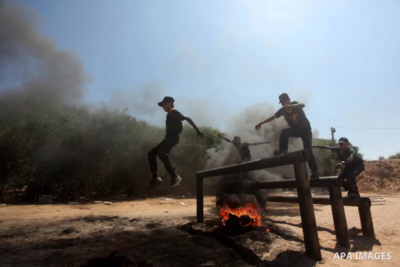 Palestinian youths take part in a military-style exercise during a summer camp organized by Islamic Jihad movement, in Gaza city, on August 13, 2015. Photo by Ashraf Amra