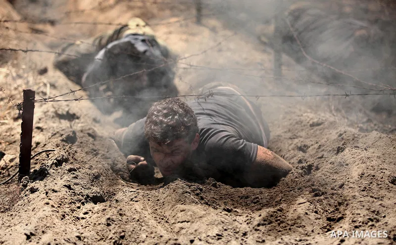 Palestinian youths take part in a military-style exercise during a summer camp organized by Islamic Jihad movement, in Gaza city, on August 13, 2015. Photo by Ashraf Amra