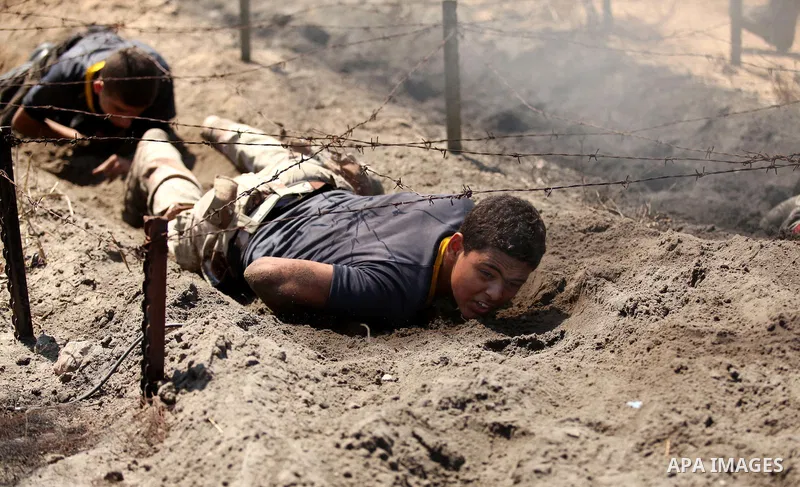 Palestinian youths take part in a military-style exercise during a summer camp organized by Islamic Jihad movement, in Gaza city, on August 13, 2015. Photo by Ashraf Amra