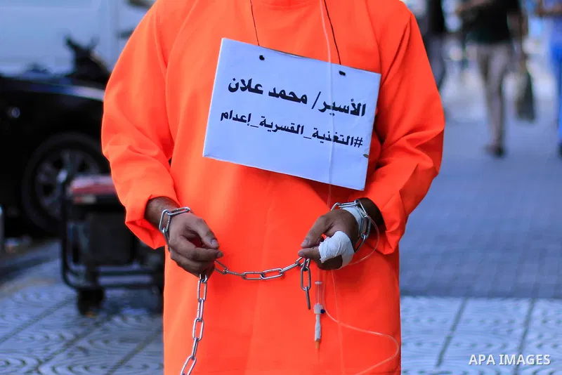 A man wearing prisoner's costume, walks in a street in solidarity with Mohammad Allan, a Palestinian prisoner in Israeli jail who has been on hunger strike for 60 consecutive days, in Gaza city on August 13, 2015. Allan,...