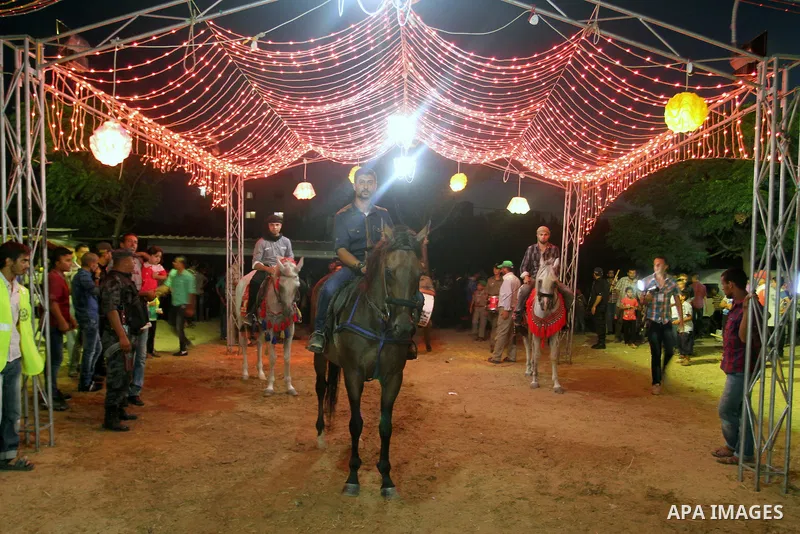 Palestinians celebrate during a mass wedding for 53 couples in Khan Younis in the southern Gaza Strip August 13, 2015. The wedding was funded by the Islamic Society. Photo by Abed Rahim Khatib