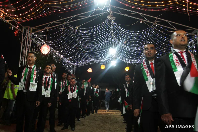 Palestinian grooms take part in a mass wedding for 53 couples in Khan Younis in the southern Gaza Strip August 13, 2015. The wedding was funded by the Islamic Society. Photo by Abed Rahim Khatib
