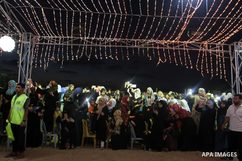 Palestinians celebrate during a mass wedding for 53 couples in Khan Younis in the southern Gaza Strip August 13, 2015. The wedding was funded by the Islamic Society. Photo by Abed Rahim Khatib
