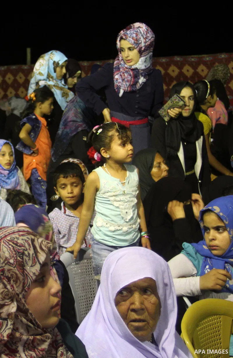 Palestinians celebrate during a mass wedding for 53 couples in Khan Younis in the southern Gaza Strip August 13, 2015. The wedding was funded by the Islamic Society. Photo by Abed Rahim Khatib