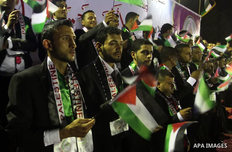Palestinian grooms sit on the stage during a mass wedding for 53 couples in Khan Younis in the southern Gaza Strip August 13, 2015. The wedding was funded by the Islamic Society. Photo by Abed Rahim Khatib