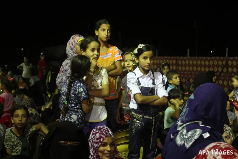 Palestinians celebrate during a mass wedding for 53 couples in Khan Younis in the southern Gaza Strip August 13, 2015. The wedding was funded by the Islamic Society. Photo by Abed Rahim Khatib