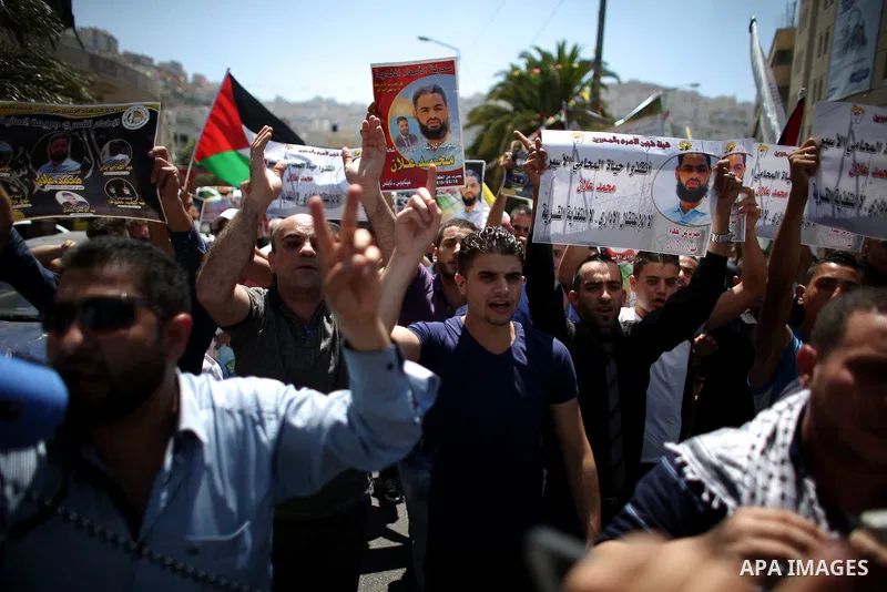 Protesters participate in a demonstration supporting the Palestinian prisoner in Israeli jails Mohammad Allan, during a protest in the West Bank city of Nablus, on August 14, 2015. The Israeli military prosecutor intends...