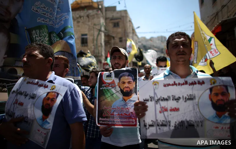 Protesters participate in a demonstration supporting the Palestinian prisoner in Israeli jails Mohammad Allan, during a protest in the West Bank city of Nablus, on August 14, 2015. The Israeli military prosecutor intends...