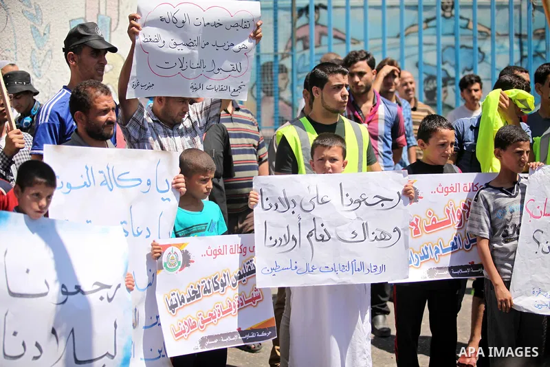 Palestinians take part in a protest against the reduction of educational programs given by the United Nations Relief and Works Agency (UNRWA) outside the UNRWA headquarters in Gaza city on August 14, 2015 . The UNRWA war...
