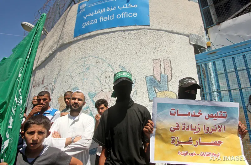 Palestinians take part in a protest against the reduction of educational programs given by the United Nations Relief and Works Agency (UNRWA) outside the UNRWA headquarters in Gaza city on August 14, 2015 . The UNRWA war...