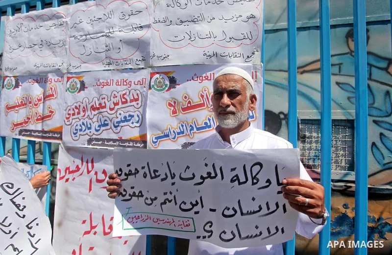 Palestinians take part in a protest against the reduction of educational programs given by the United Nations Relief and Works Agency (UNRWA) outside the UNRWA headquarters in Gaza city on August 14, 2015 . The UNRWA war...