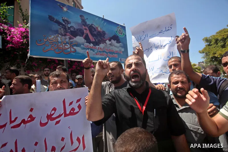 Palestinians take part in a protest against the reduction of educational programs given by the United Nations Relief and Works Agency (UNRWA) outside the UNRWA headquarters in Gaza city on August 14, 2015 . The UNRWA war...