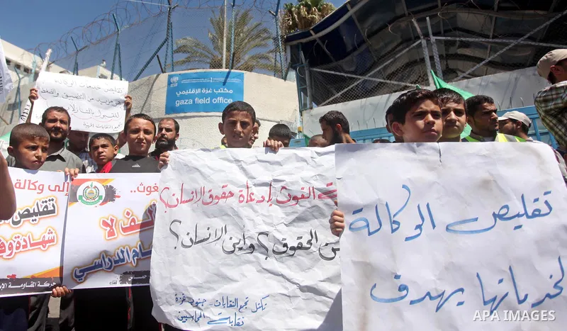 Palestinians take part in a protest against the reduction of educational programs given by the United Nations Relief and Works Agency (UNRWA) outside the UNRWA headquarters in Gaza city on August 14, 2015 . The UNRWA war...