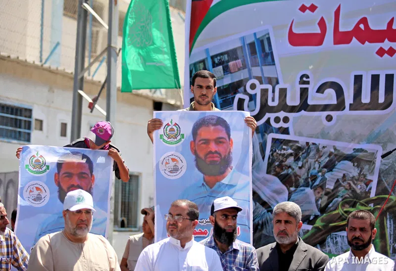 Palestinians take part in a protest against the reduction of educational programs given by the United Nations Relief and Works Agency (UNRWA) outside the UNRWA headquarters in Gaza city on August 14, 2015 . The UNRWA war...