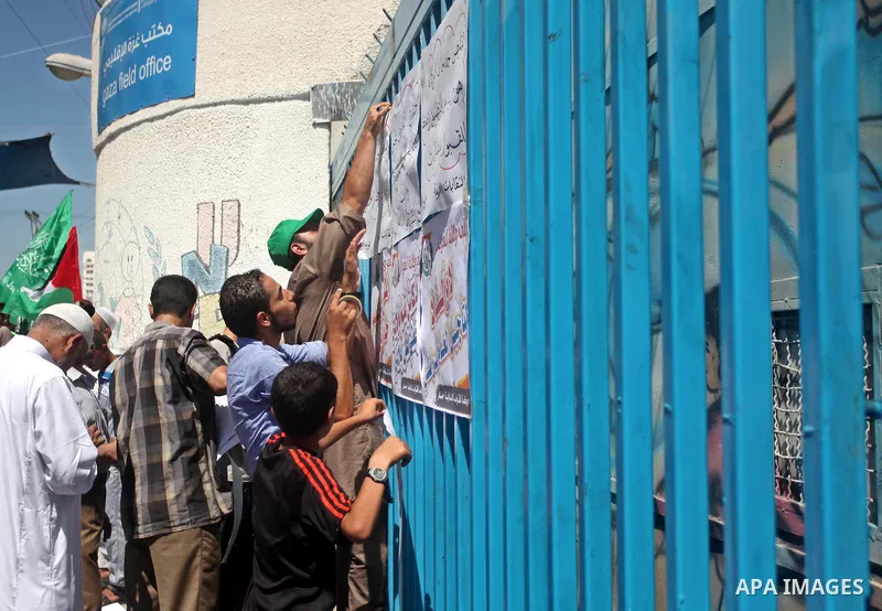 Palestinians take part in a protest against the reduction of educational programs given by the United Nations Relief and Works Agency (UNRWA) outside the UNRWA headquarters in Gaza city on August 14, 2015 . The UNRWA war...