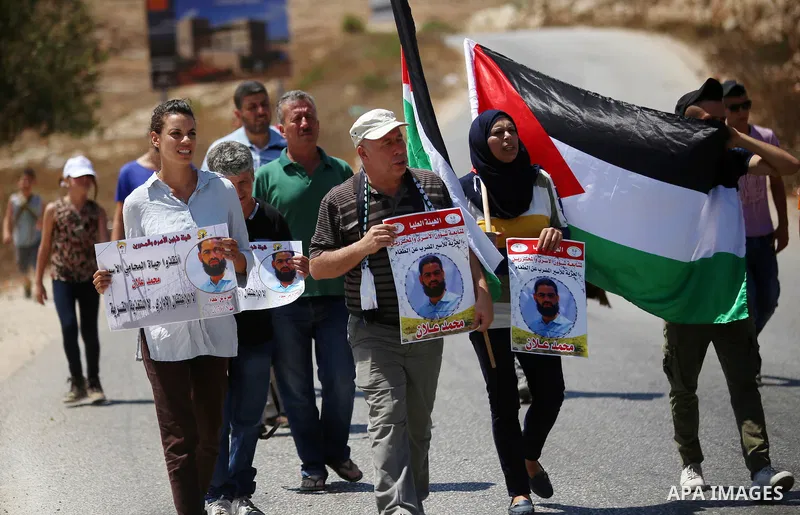 Protesters hold pictures of Palestinian prisoner Mohammad Allan, allegedly being held in an Israeli jail, during a protest in the West Bank village of Nabi Saleh, near Ramallah, 14 August 2015. According to the Palestini...