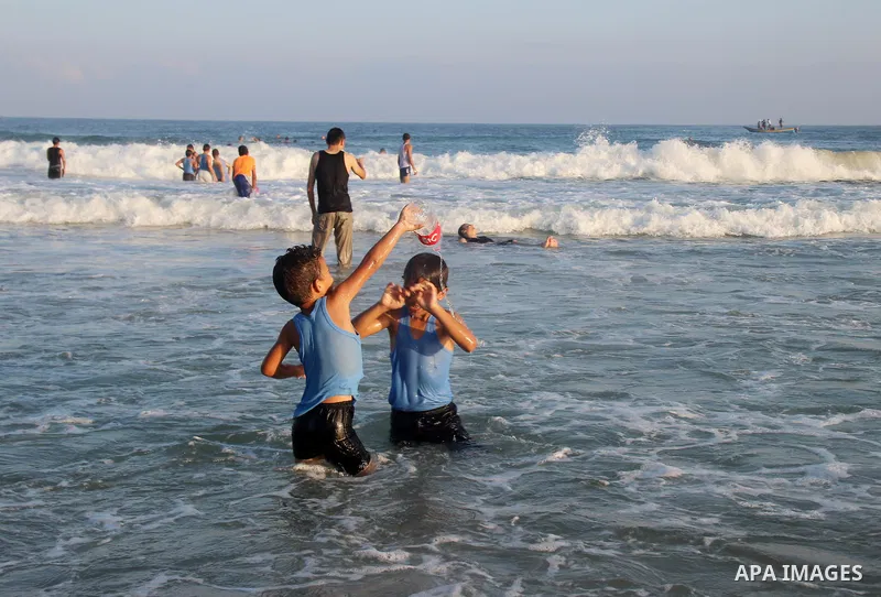 Palestinians enjoy the beach of the Mediterranean Sea on the coast of Gaza City on August 14, 2015. Photo by Khaled Dawood