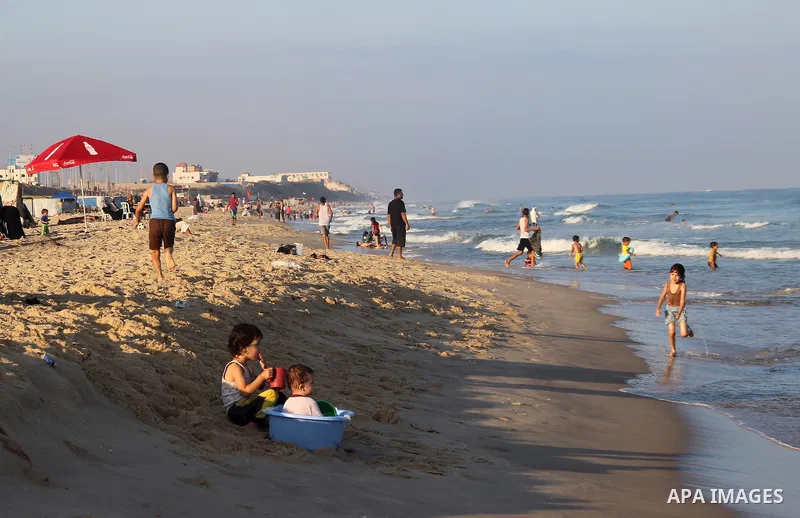 Palestinians enjoy the beach of the Mediterranean Sea on the coast of Gaza City on August 14, 2015. Photo by Khaled Dawood