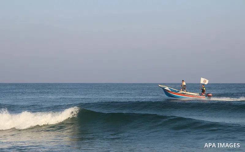 Palestinians ride a boat in the Mediterranean Sea on the coast of Gaza City on August 14, 2015. Photo by Khaled Dawood