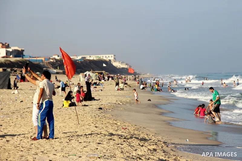 Palestinians enjoy the beach of the Mediterranean Sea on the coast of Gaza City on August 14, 2015. Photo by Khaled Dawood