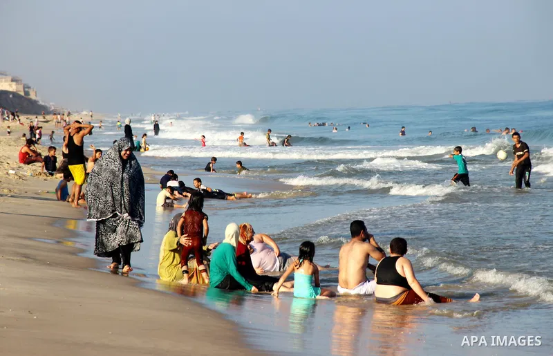 Palestinians enjoy the beach of the Mediterranean Sea on the coast of Gaza City on August 14, 2015. Photo by Khaled Dawood