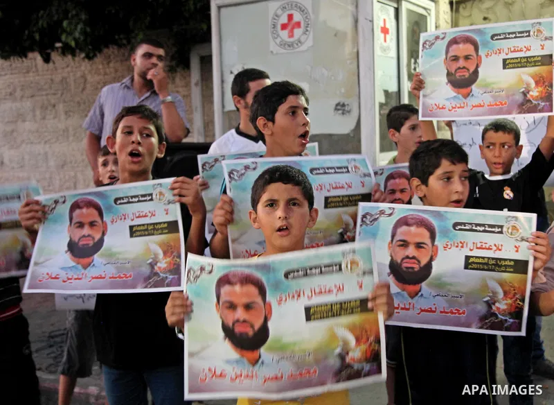 Palestinian children hold pictures of prisoner Mohammad Allan, allegedly being held in an Israeli jail, during a protest outside the Red Cross headquarter, in Gaza city on August 14, 2015. The Israeli military prosecutor...