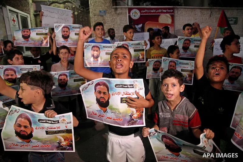 Palestinian children hold pictures of prisoner Mohammad Allan, allegedly being held in an Israeli jail, during a protest outside the Red Cross headquarter, in Gaza city on August 14, 2015. The Israeli military prosecutor...