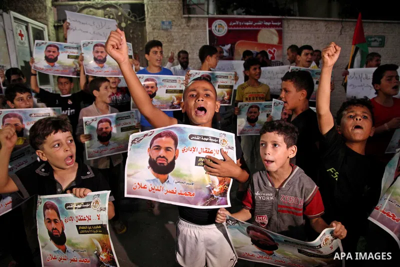 Palestinian children hold pictures of prisoner Mohammad Allan, allegedly being held in an Israeli jail, during a protest outside the Red Cross headquarter, in Gaza city on August 14, 2015. The Israeli military prosecutor...