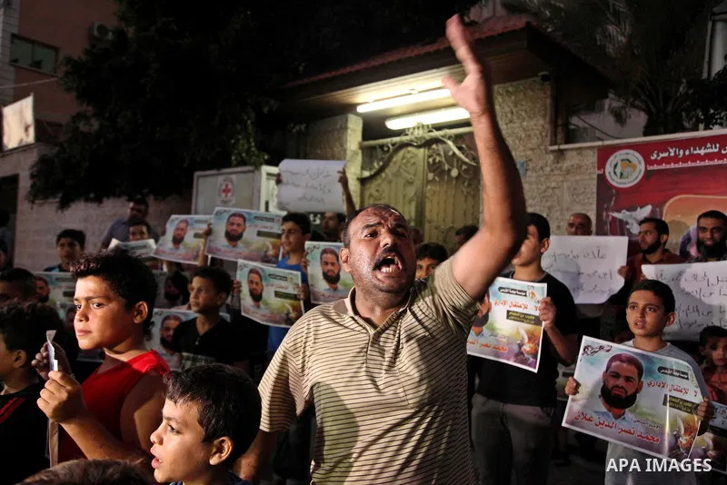 Palestinian children hold pictures of prisoner Mohammad Allan, allegedly being held in an Israeli jail, during a protest outside the Red Cross headquarter, in Gaza city on August 14, 2015. The Israeli military prosecutor...