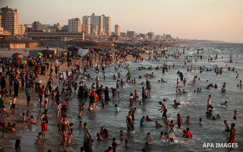 Palestinians enjoy a hot day at the beach of the Mediterranean Sea on the coast of Gaza City on August 14, 2015. Photo by Ashraf Amra