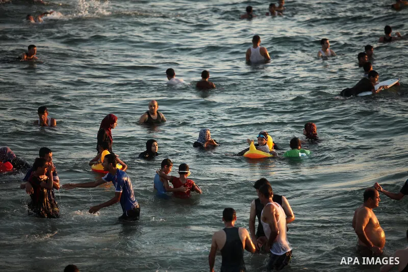 Palestinians enjoy a hot day at the beach of the Mediterranean Sea on the coast of Gaza City on August 14, 2015. Photo by Ashraf Amra