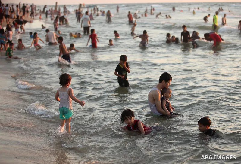 Palestinians enjoy a hot day at the beach of the Mediterranean Sea on the coast of Gaza City on August 14, 2015. Photo by Ashraf Amra