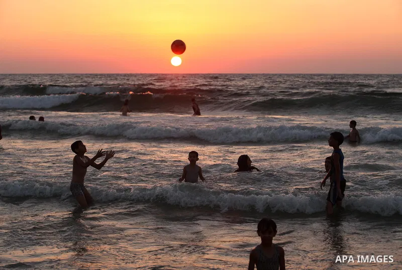 Palestinians enjoy a hot day at the beach of the Mediterranean Sea on the coast of Gaza City on August 14, 2015. Photo by Ashraf Amra