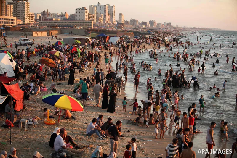 Palestinians enjoy a hot day at the beach of the Mediterranean Sea on the coast of Gaza City on August 14, 2015. Photo by Ashraf Amra