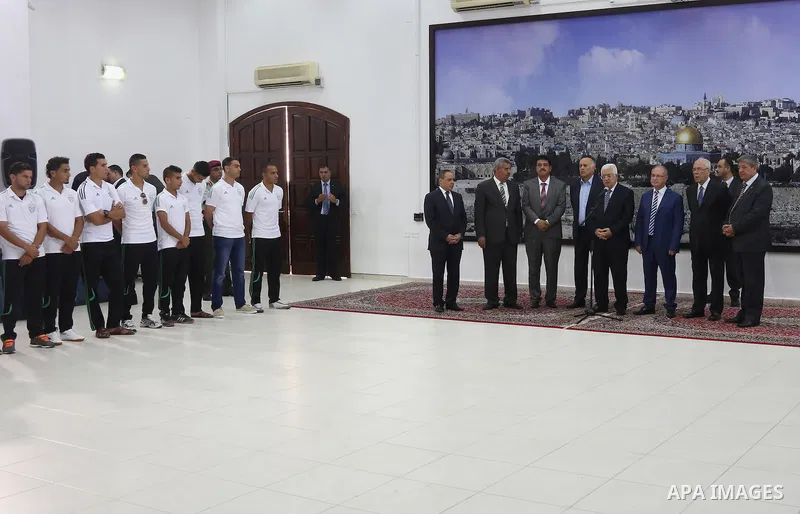 Palestinian President, Mahmoud Abbas (Abu Mazen) meets with Gaza Strip's Shejaiya's players and Hebron's Al-Ahly's players, in the West Bank city of Ramallah, on August 15, 2015. Photo by Osama Falah