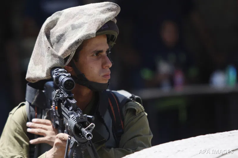 An Israeli soldier stand guard during a demonstration in solidarity with Palestinian of prisoner Mohammad Allan, allegedly being held in an Israeli jail, at Israeli checkpoint of Hawara, near the West Bank city of Nablus...