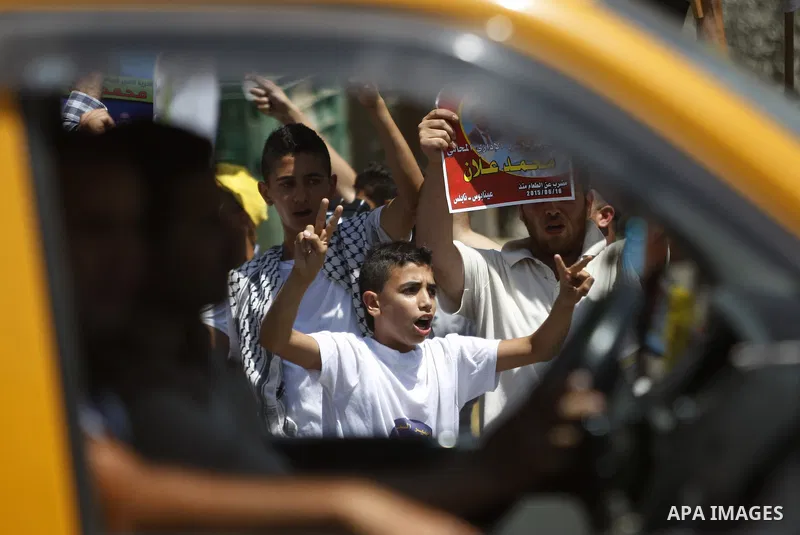 Palestinian protesters shout slogans during a demonstration in solidarity with Palestinian of prisoner Mohammad Allan, allegedly being held in an Israeli jail, at Israeli checkpoint of Hawara, near the West Bank city of...