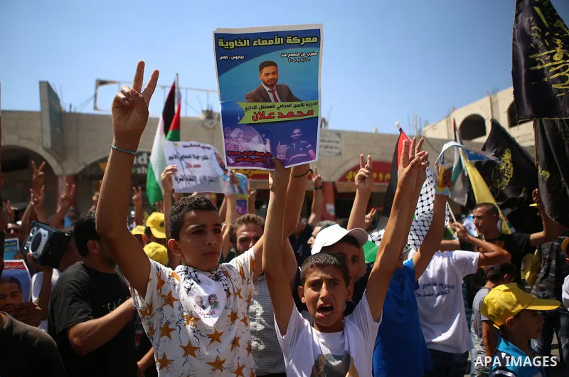 Palestinian protesters shout slogans during a demonstration in solidarity with Palestinian of prisoner Mohammad Allan, allegedly being held in an Israeli jail, at Israeli checkpoint of Hawara, near the West Bank city of...