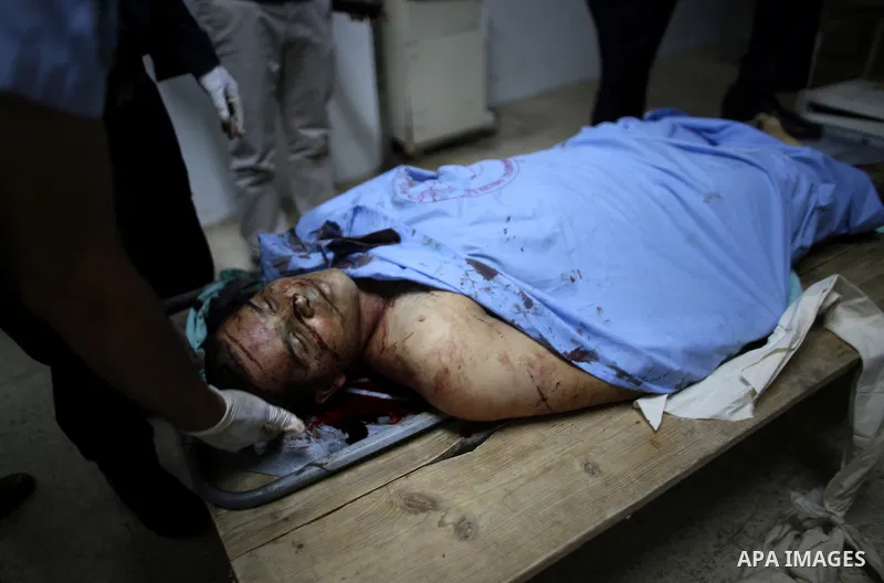 Relatives of Rafiq Kamel Al-Taj, a 21-year-old Palestinian man stand over his body at a morgue, in Rafidia Governmental Hospital in the West Bank city of Nablus on August 15, 2015. A police spokesperson said that Israeli...