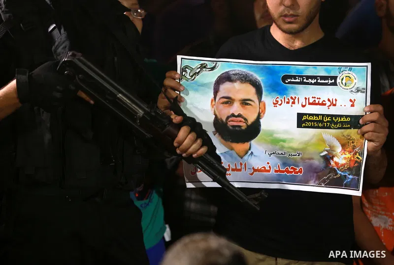 Members of Islamic Jihad movement hold pictures of prisoner Mohammad Allan allegedly being held in an Israeli jail, during a protest in Gaza city on August 15, 2015. The Israeli military prosecutor intends to request cou...
