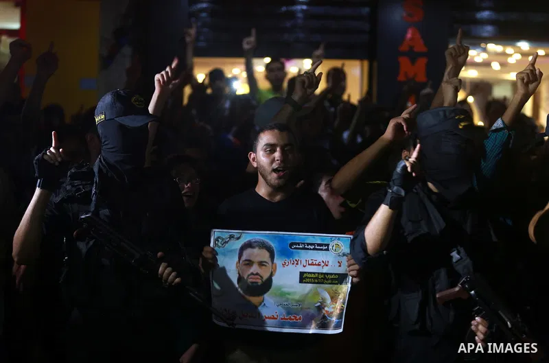 Members of Islamic Jihad movement hold pictures of prisoner Mohammad Allan allegedly being held in an Israeli jail, during a protest in Gaza city on August 15, 2015. The Israeli military prosecutor intends to request cou...