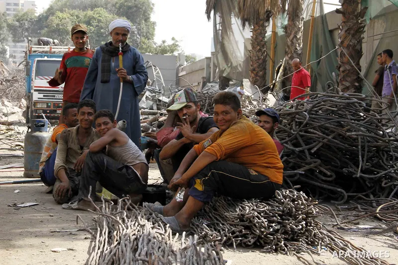 Egyptian laborers break during the demolition of the headquarters of the once-dominant party of ex-president Hosni Mubarak that was torched during the 2011 uprising that toppled him, on August 16, 2015 in the capital, Ca...
